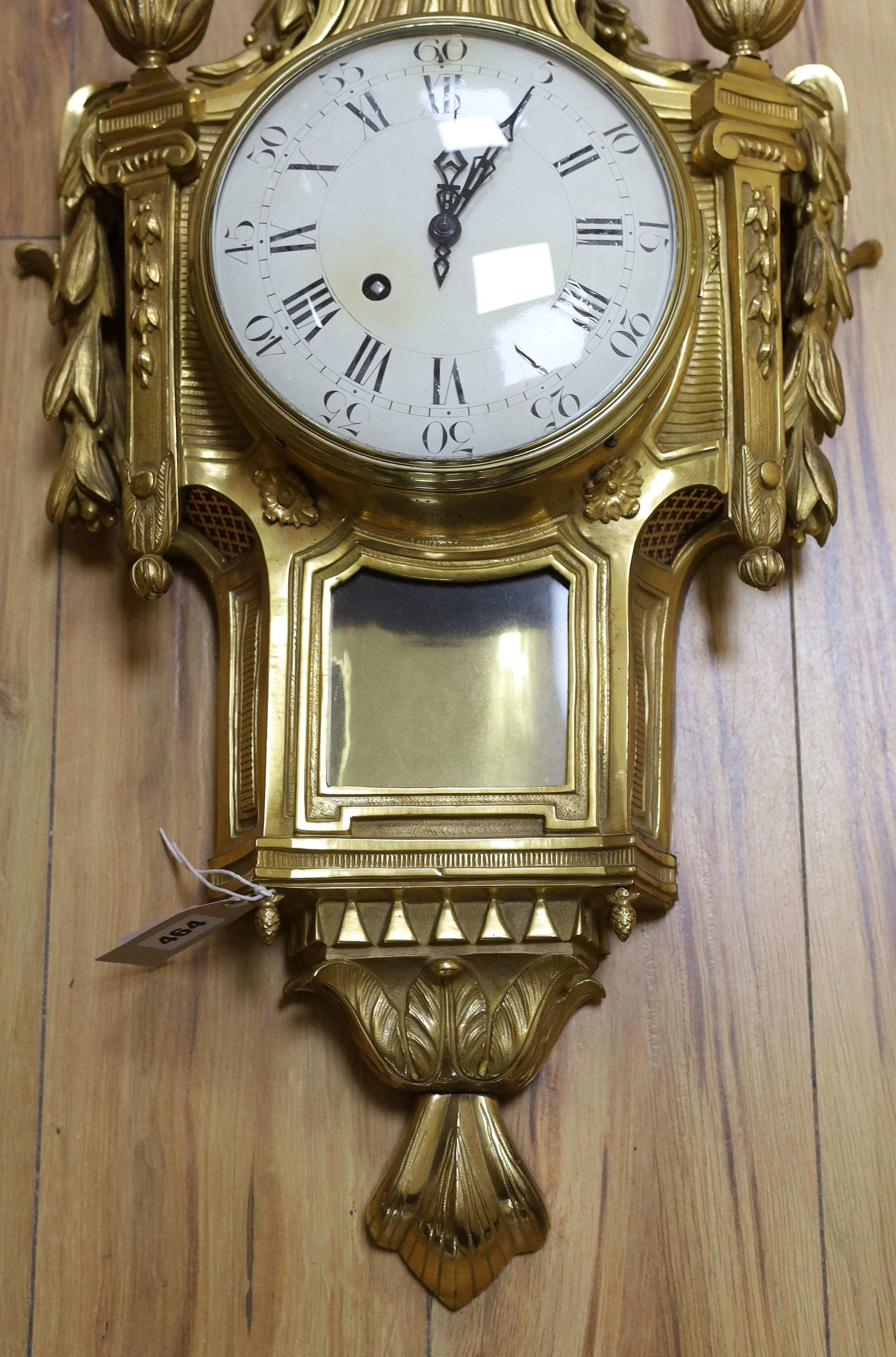 A decorative brass Cartel wall clock - 80cm tall